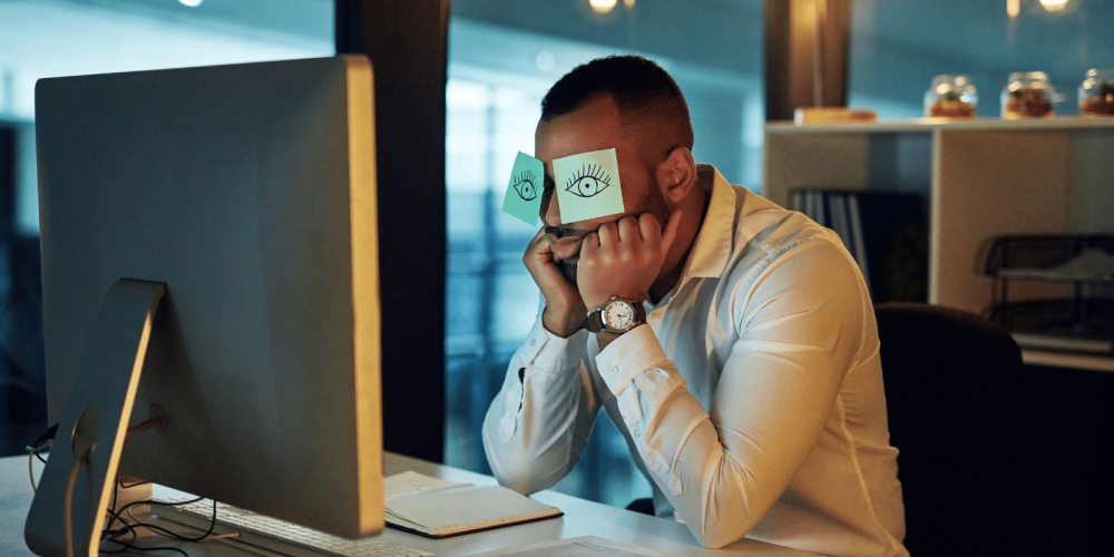 Tired office worker with post-its on his face